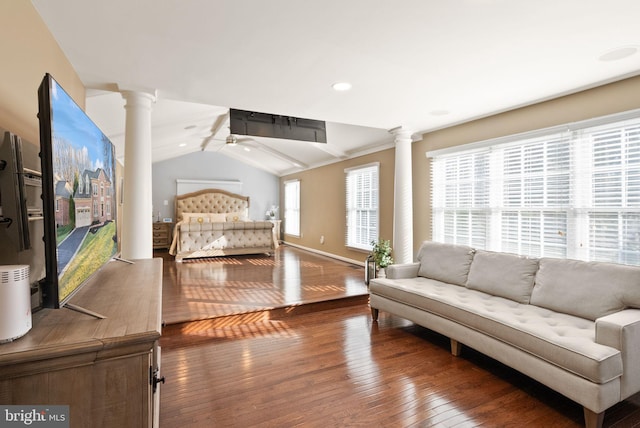 bedroom featuring decorative columns, lofted ceiling, and dark hardwood / wood-style floors