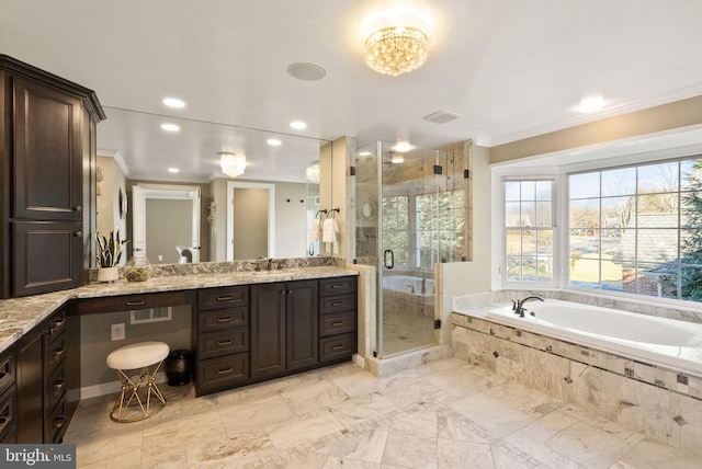 bathroom featuring vanity, ornamental molding, and independent shower and bath