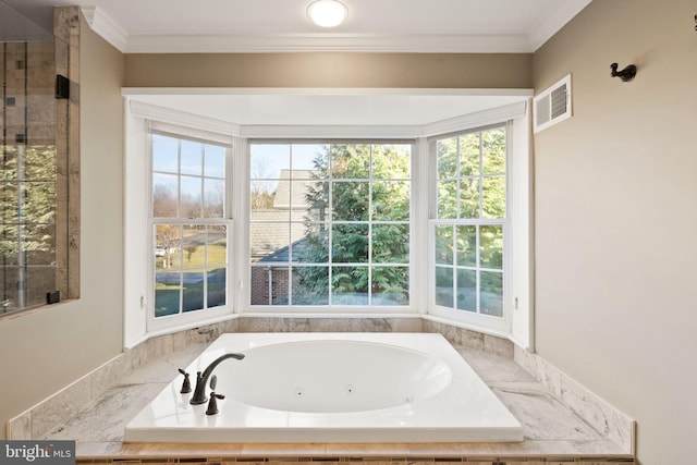 bathroom featuring crown molding and tiled bath