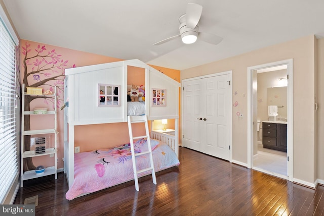 bedroom with hardwood / wood-style flooring, ceiling fan, ensuite bathroom, and a closet