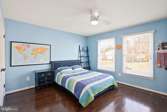 bedroom with dark hardwood / wood-style flooring and ceiling fan