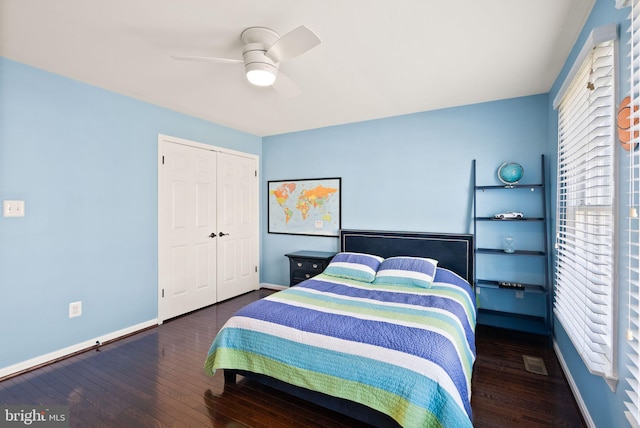 bedroom with dark wood-type flooring, a closet, and ceiling fan