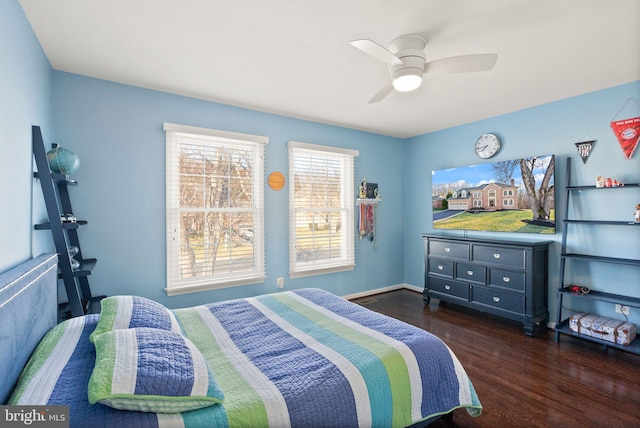 bedroom with ceiling fan and dark hardwood / wood-style floors