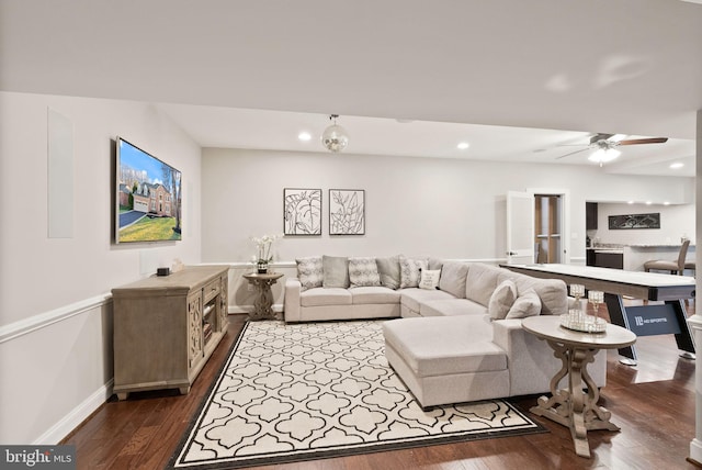 living room with ceiling fan and dark hardwood / wood-style floors