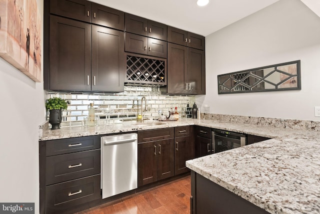 bar featuring dark brown cabinets, sink, wine cooler, and dark hardwood / wood-style floors