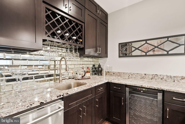 kitchen featuring sink, wine cooler, decorative backsplash, stainless steel dishwasher, and dark brown cabinetry