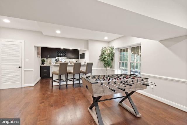 recreation room featuring dark wood-type flooring and bar area