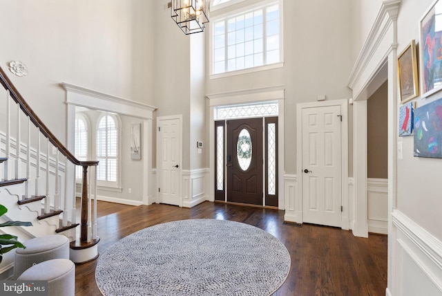 entrance foyer with dark wood-type flooring and a notable chandelier