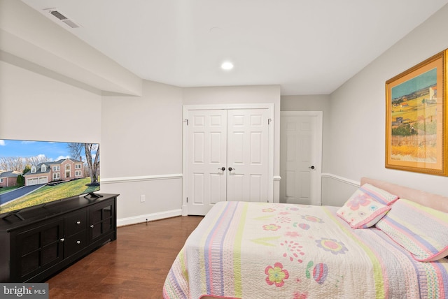 bedroom with a closet and dark hardwood / wood-style floors