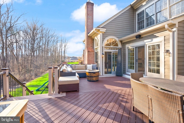 wooden terrace with an outdoor hangout area