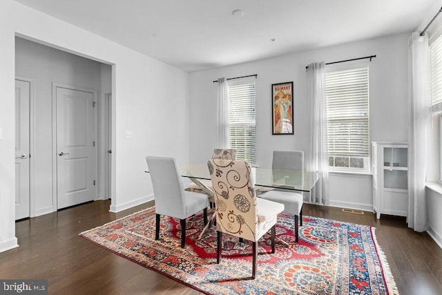 dining room with dark hardwood / wood-style flooring