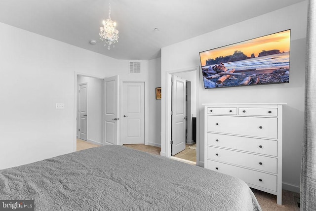 carpeted bedroom with a notable chandelier