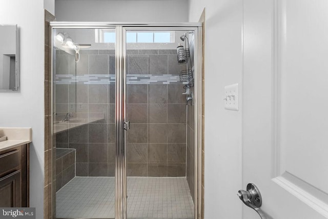 bathroom featuring vanity and an enclosed shower