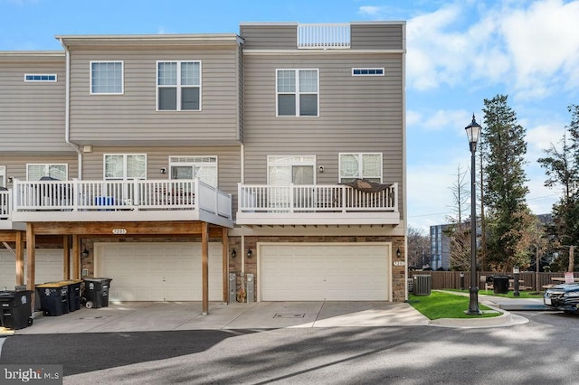 back of property featuring a garage and central AC