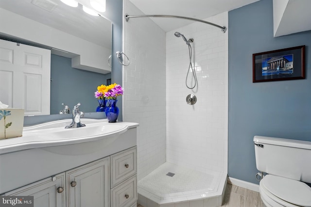 12240 Nutmeg Ct, Woodbridge, VA 22192 - bathroom with toilet, visible vents, a tile shower, and vanity