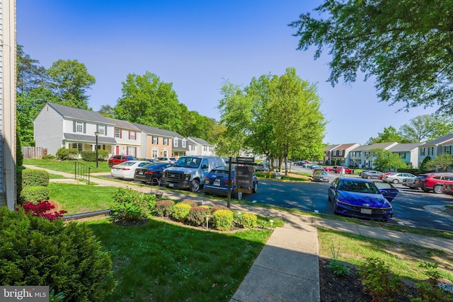 12240 Nutmeg Ct, Woodbridge, VA 22192 - uncovered parking lot featuring a residential view