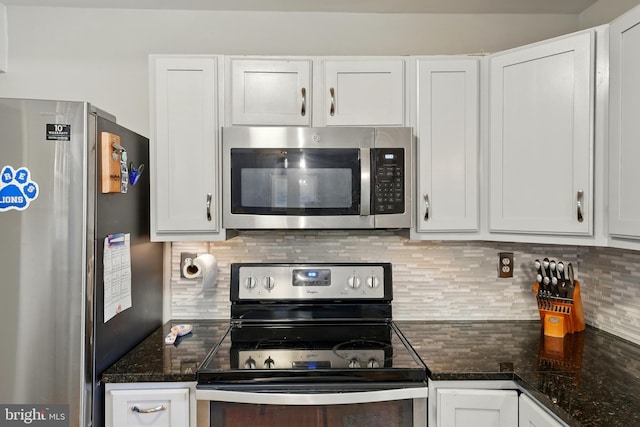 12240 Nutmeg Ct, Woodbridge, VA 22192 - kitchen with dark stone counters, backsplash, white cabinets, and stainless steel appliances