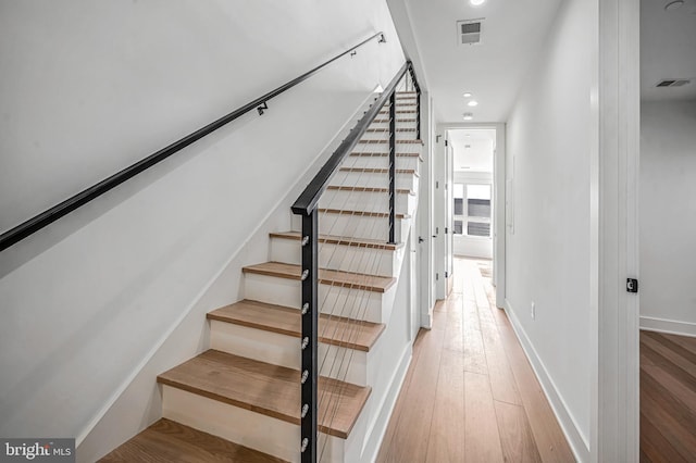 stairs with wood-type flooring
