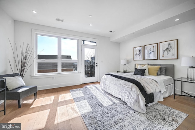 bedroom with access to outside and light hardwood / wood-style flooring