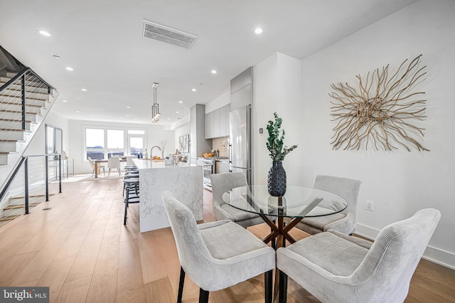 dining room with light hardwood / wood-style flooring
