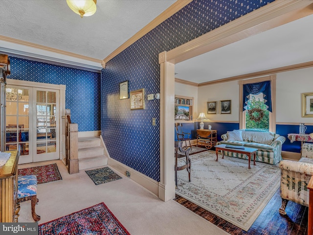 interior space featuring crown molding, carpet, a textured ceiling, and french doors