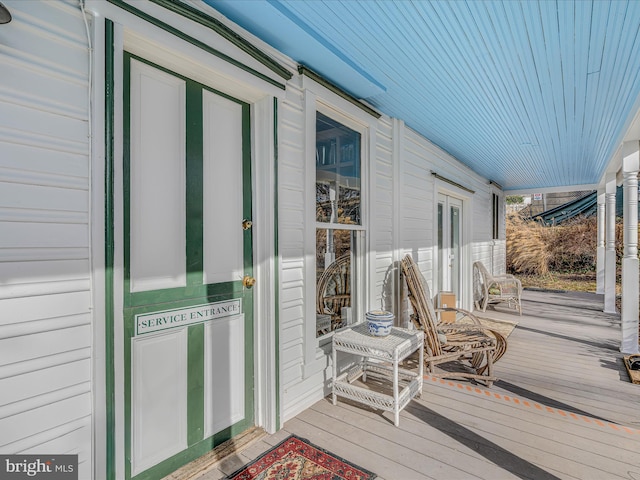 wooden terrace with a porch