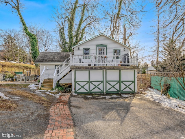 view of front of property featuring a wooden deck and a garage