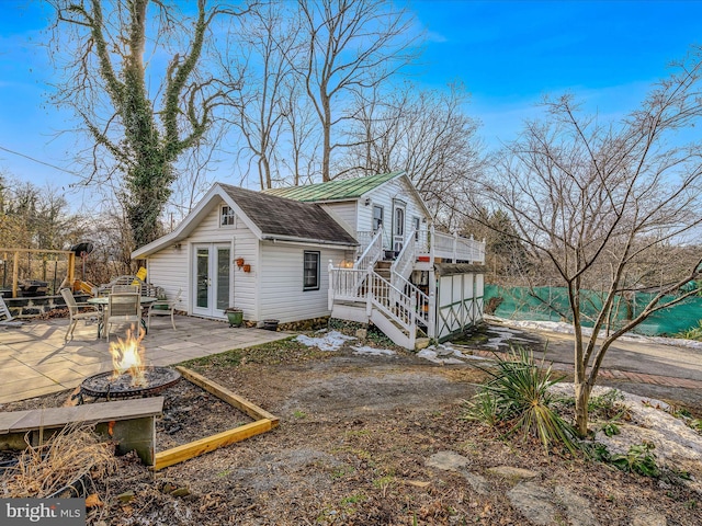 back of house featuring a fire pit, a patio area, and french doors