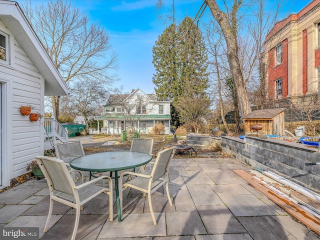 view of patio / terrace featuring a storage unit