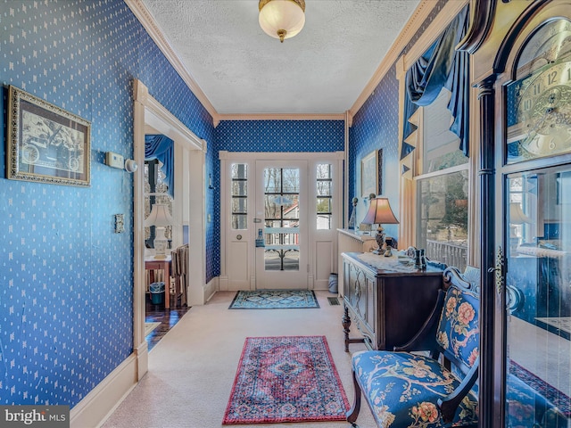 carpeted entrance foyer featuring crown molding and a textured ceiling