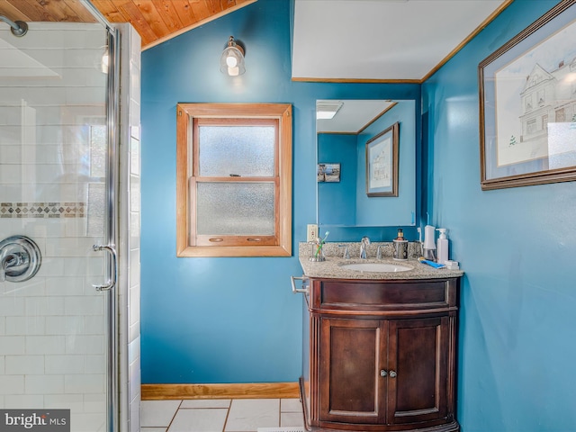 bathroom with vaulted ceiling, vanity, tile patterned floors, and a shower with shower door