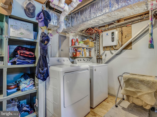 washroom featuring independent washer and dryer and light hardwood / wood-style flooring