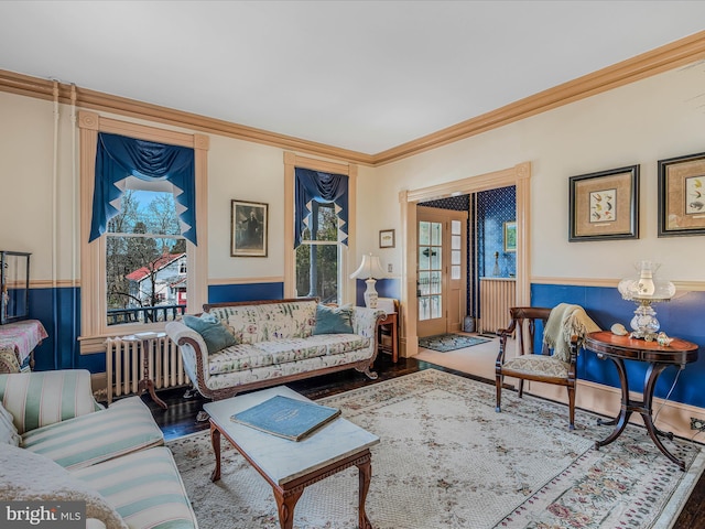 living room with ornamental molding and hardwood / wood-style floors