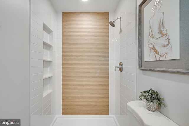 bathroom with tiled shower