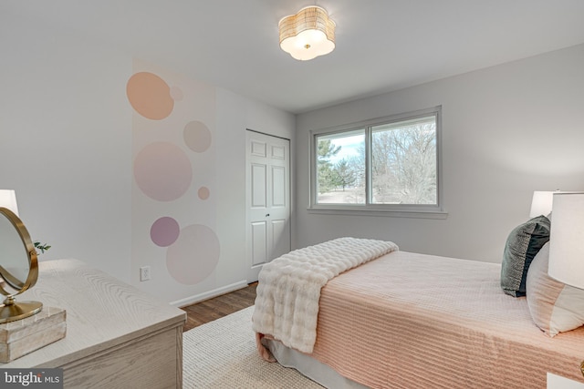 bedroom featuring hardwood / wood-style floors and a closet