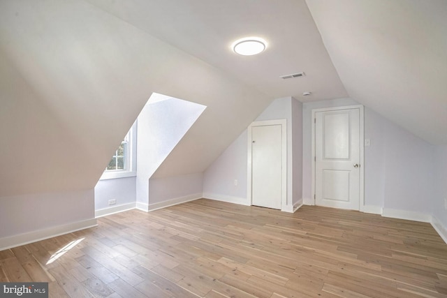 bonus room featuring lofted ceiling and light wood-type flooring