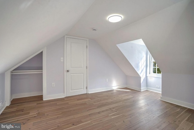 bonus room featuring lofted ceiling and hardwood / wood-style floors