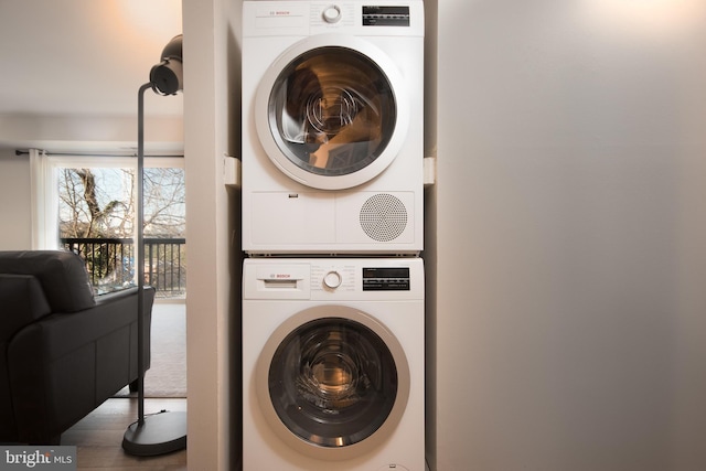 clothes washing area with stacked washer and dryer