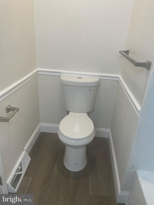 bathroom with hardwood / wood-style floors and toilet