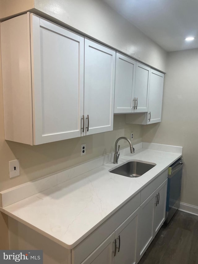 clothes washing area with sink and dark hardwood / wood-style floors