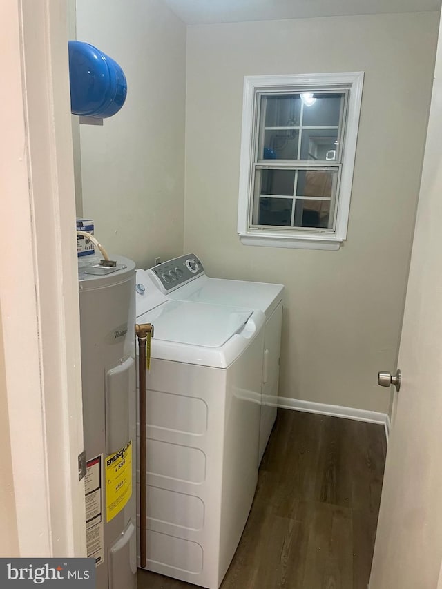 washroom featuring water heater, dark hardwood / wood-style flooring, and washer and dryer