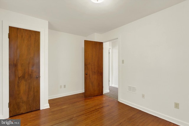 unfurnished bedroom featuring hardwood / wood-style flooring