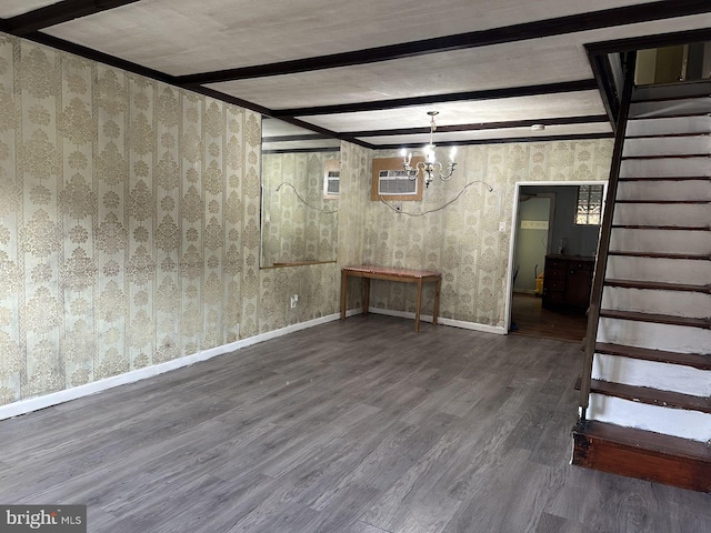 basement featuring dark wood-type flooring, a wall mounted AC, and a chandelier