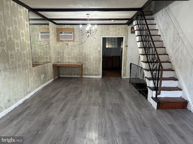 basement featuring dark hardwood / wood-style floors, a chandelier, and a wall unit AC