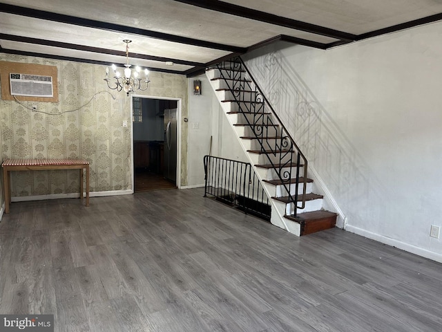 basement with an inviting chandelier, hardwood / wood-style floors, an AC wall unit, and stainless steel refrigerator with ice dispenser