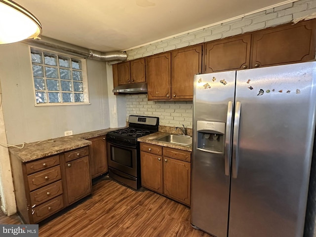 kitchen featuring sink, decorative backsplash, dark hardwood / wood-style floors, and appliances with stainless steel finishes