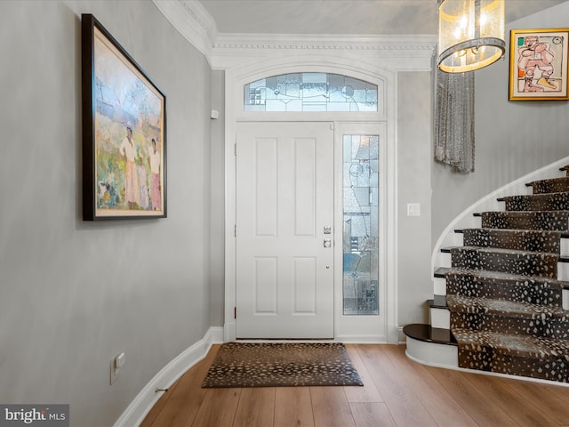 entrance foyer with stairway, baseboards, and wood finished floors