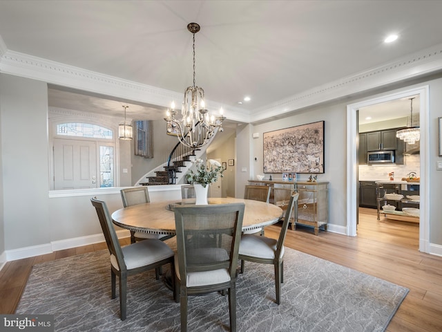 dining space with recessed lighting, stairway, baseboards, and wood finished floors