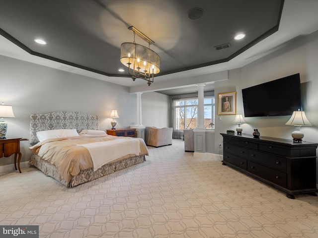 bedroom with visible vents, baseboards, a tray ceiling, decorative columns, and recessed lighting