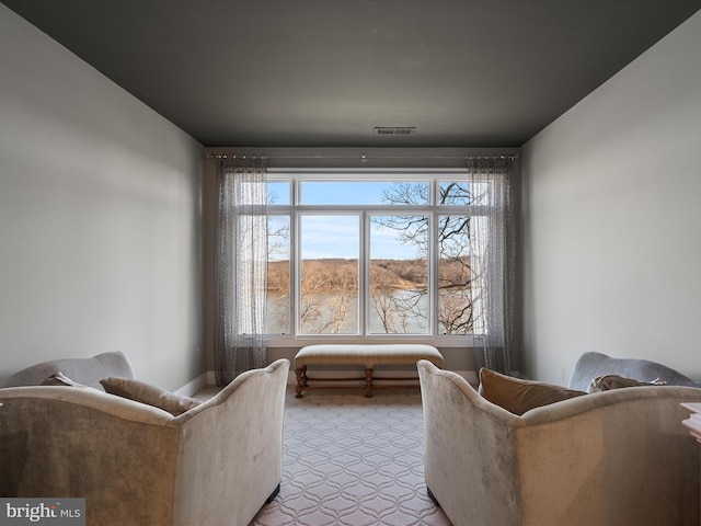 living room featuring visible vents and light colored carpet